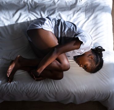 Woman experiencing menstrual pain - Naija Fitfam