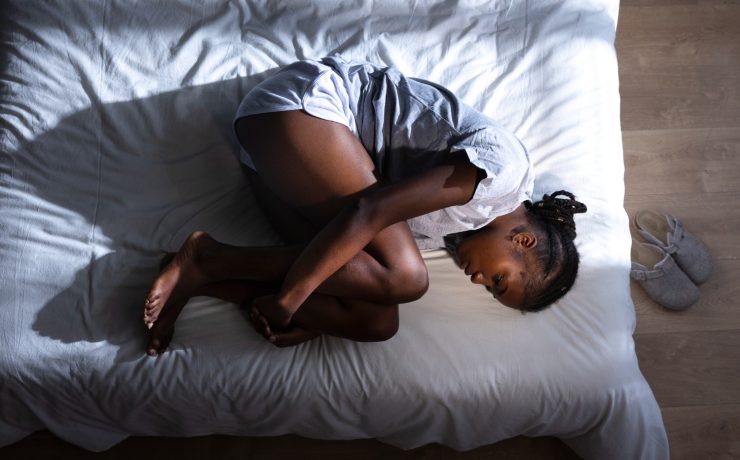 Woman experiencing menstrual pain - Naija Fitfam